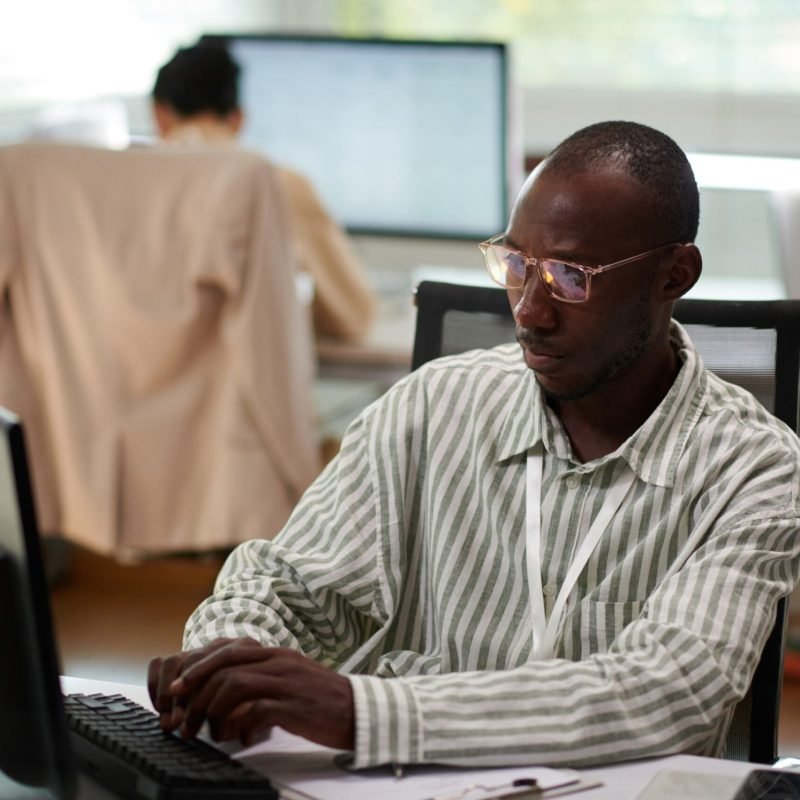 businessman-filling-document-at-office-desk-2026-01-07-07-05-20-utc (1) (1) (1)