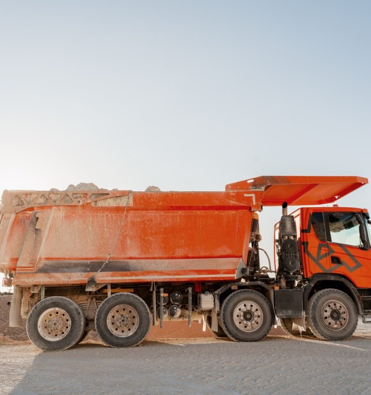 large-orange-dumper-truck-carrying-stones-in-a-qua-2026-01-07-06-34-36-utc (1) (1) (1)