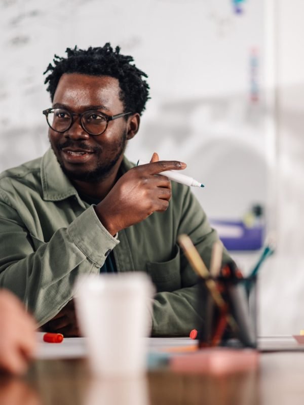 smiling-businessman-explaining-strategy-during-off-2026-01-09-08-39-32-utc (1)